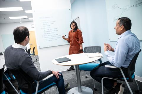 People collaborating around a whiteboard